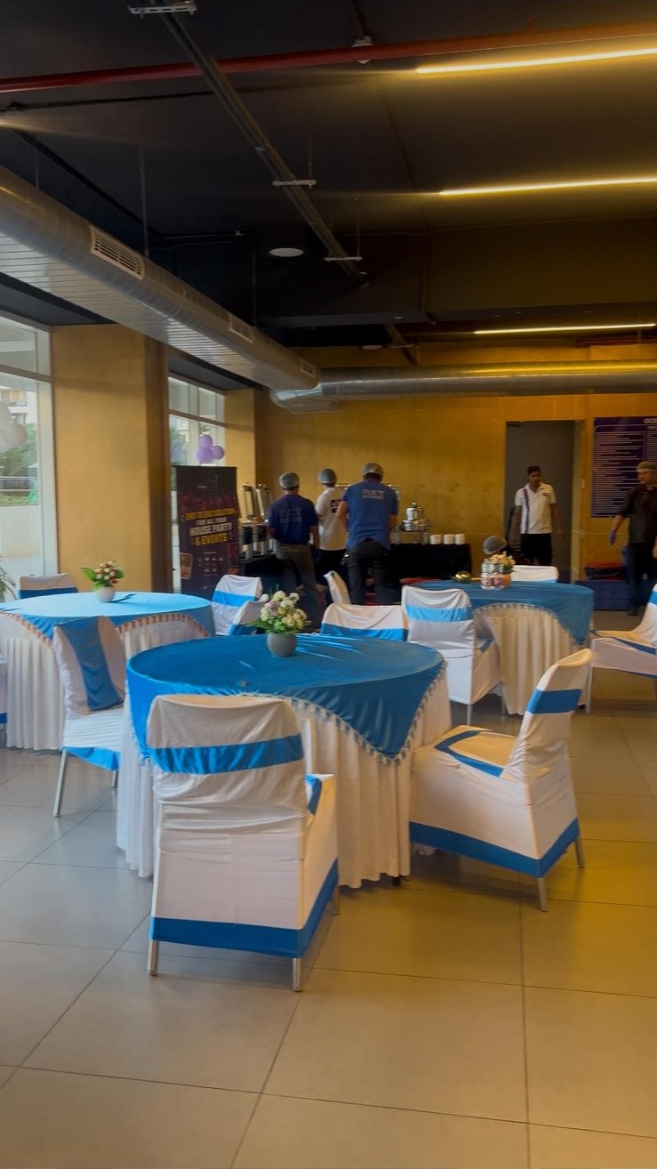 Elegant banquet dining setup with draped tables and TVH hospitality staff